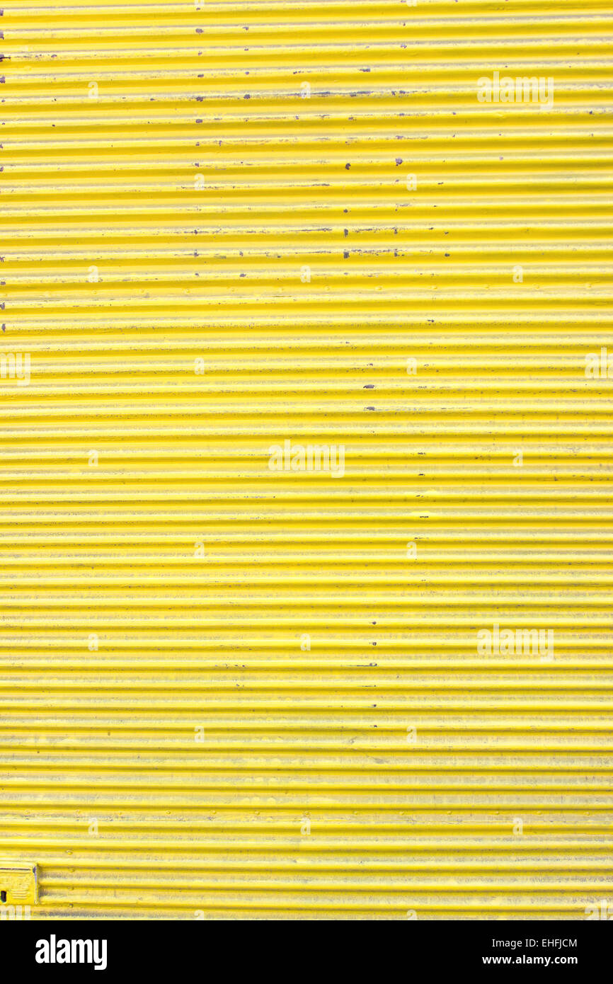 Yellow corrugated metal sheet slide door as background Stock Photo