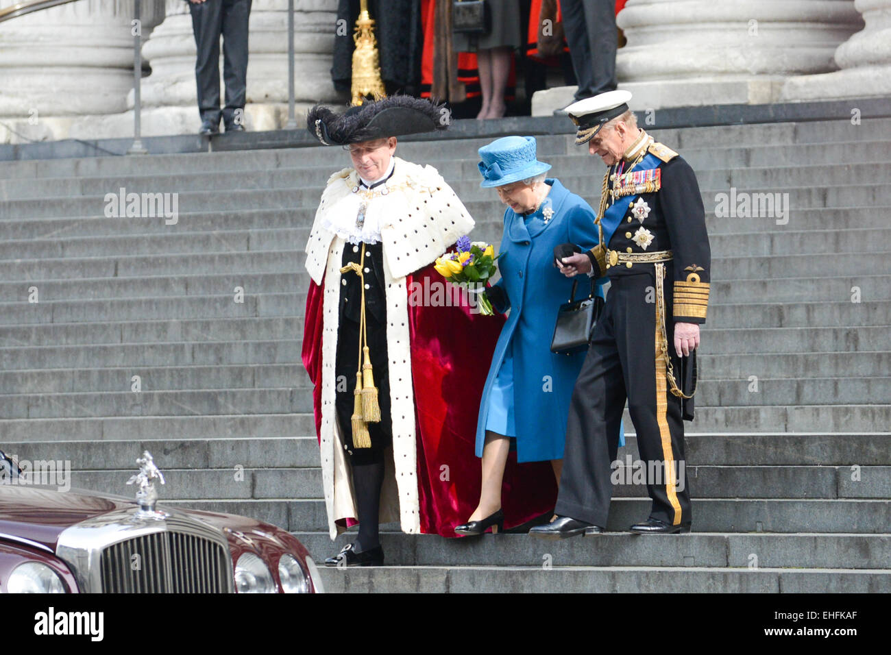 St Paul's Cathedral, London, UK. 13th March 2015. The Queen is held as she walks down the steps with Prince Philip as they attend a service and parade at St Paul's Cathedral to mark the end of combat operations in Afghanistan. Credit:  Matthew Chattle/Alamy Live News Stock Photo