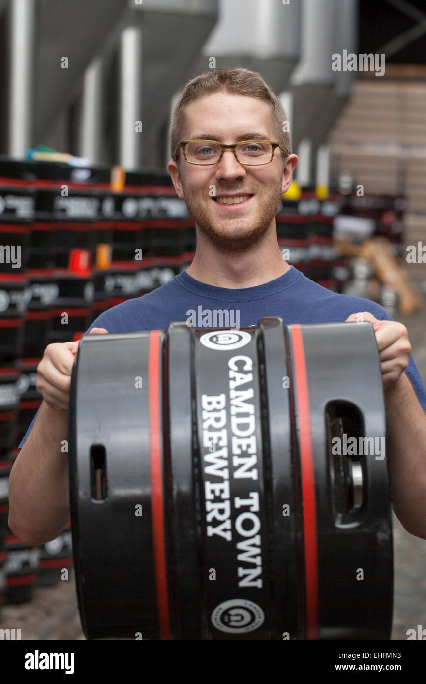 Staff holding Beer Barrel at the Camden Town Brewery London Stock Photo