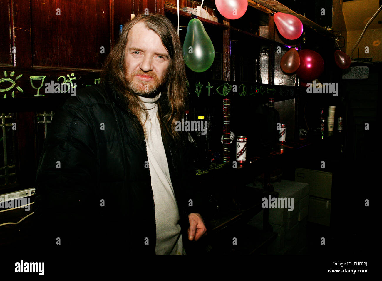 Man with long hair at a squat party in South East London. Stock Photo