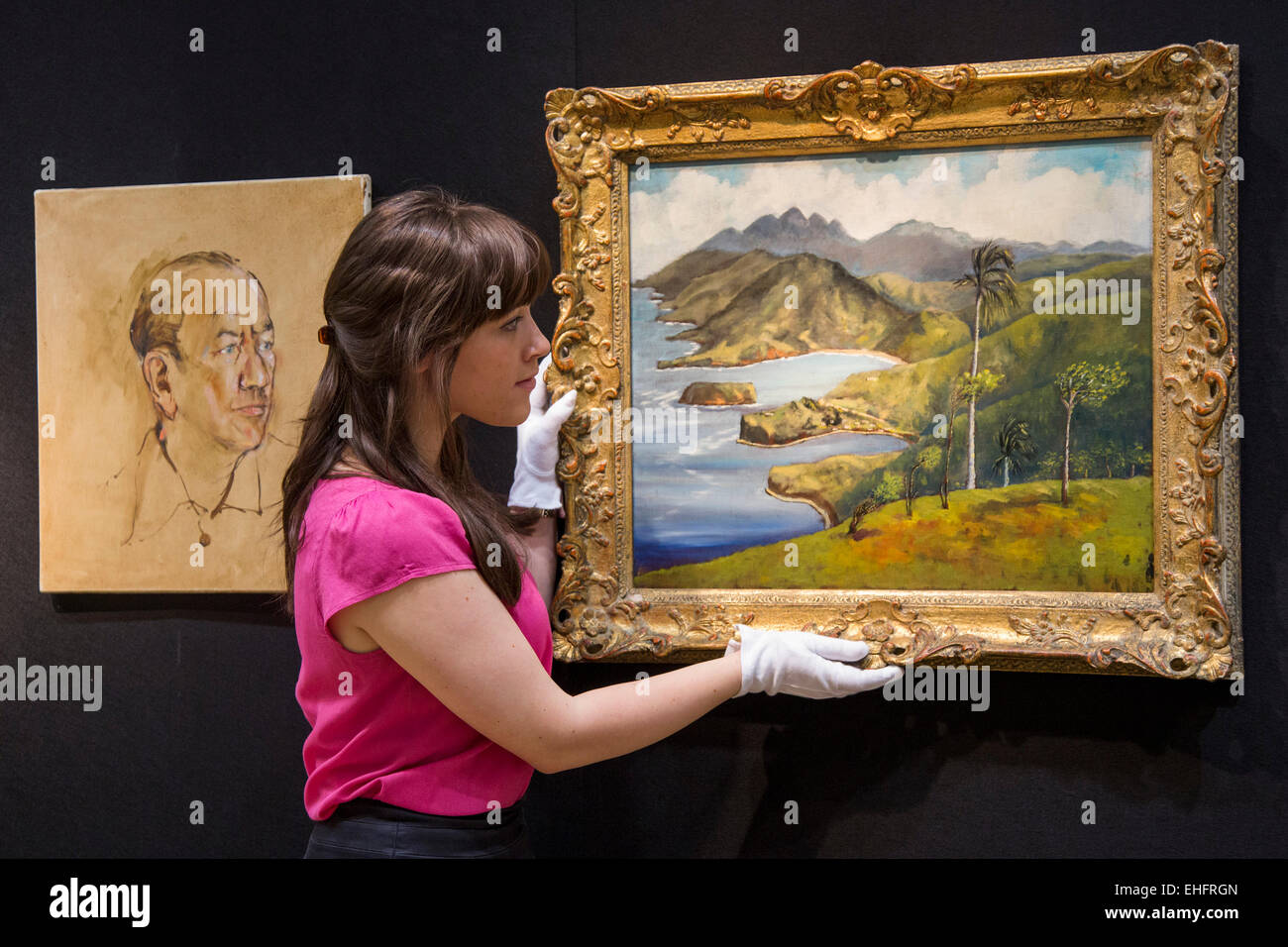 London, UK. 13 March 2015. A Christie's employee holds up the oil painting "A View from Firefly" by Sir Noël Coward, estimate: GBP 10,000-15,000. Christie's announces the sale of a selection of artworks formerly in the private collection of Sir Noël Coward, which will be offered as part of the Modern British and Irish Art sale on 19 March 2015 at South Kensington. The collection features paintings by Coward himself and paintings he acquired and those that were gifted to him by famous friends. Photo: Bettina Strenske Stock Photo