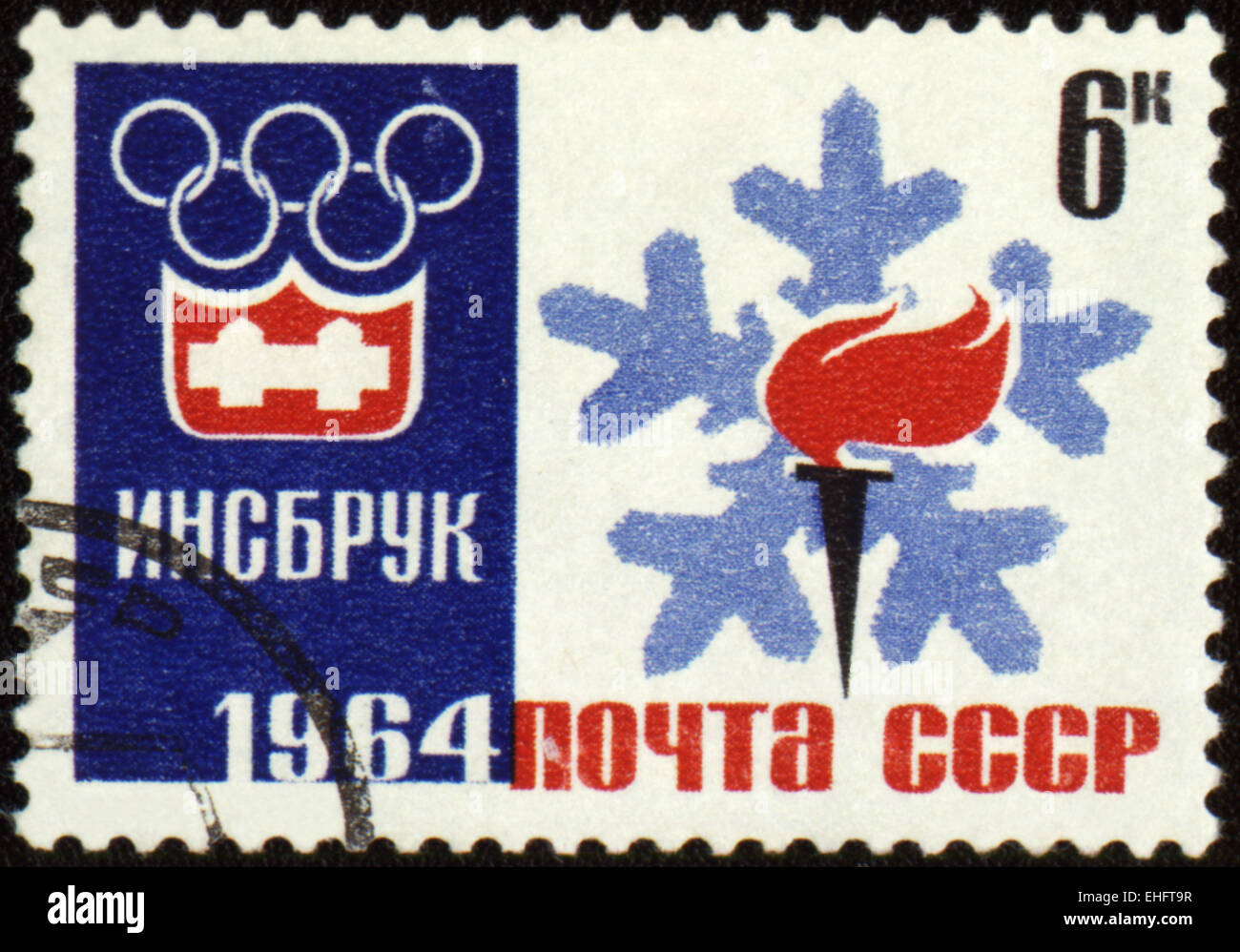 USSR - CIRCA 1964: A post stamp printed in USSR shows Olympic emblem and torch with flame Stock Photo