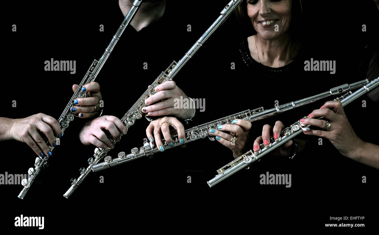 Flute Quartet, close up on hands with black background. Hands on my flute, many flutists. Flute Jazz Quartet. Classical flute quartet Stock Photo