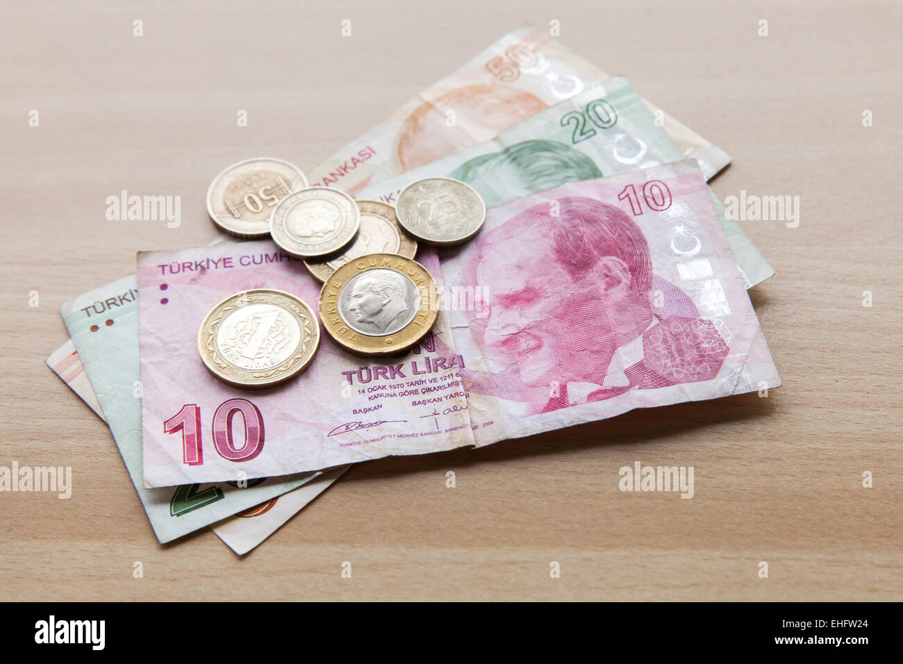 Different banknotes and coins. Turkish money with Ataturk portrait on wooden table background Stock Photo