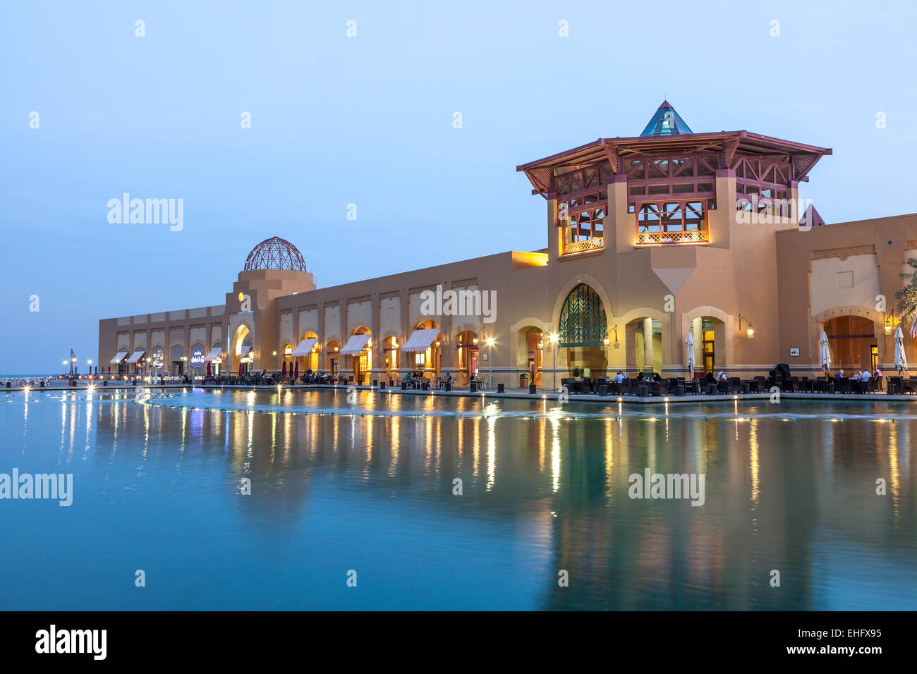 Al Kout Mall at dusk. Al Kout Mall is a modern shopping mall in