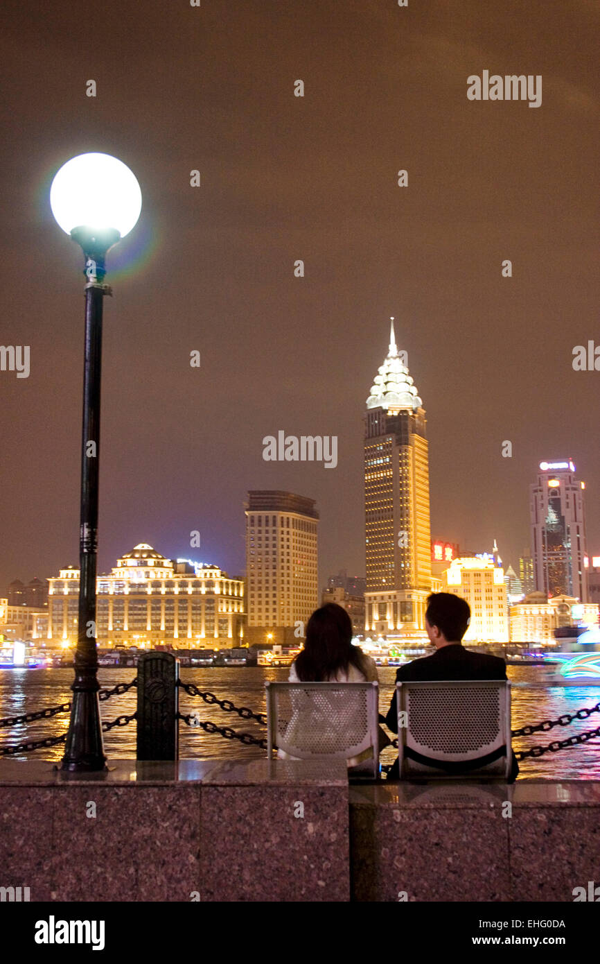 A couple spend a romantic evening taking in the Bund skyline Shanghai. Stock Photo