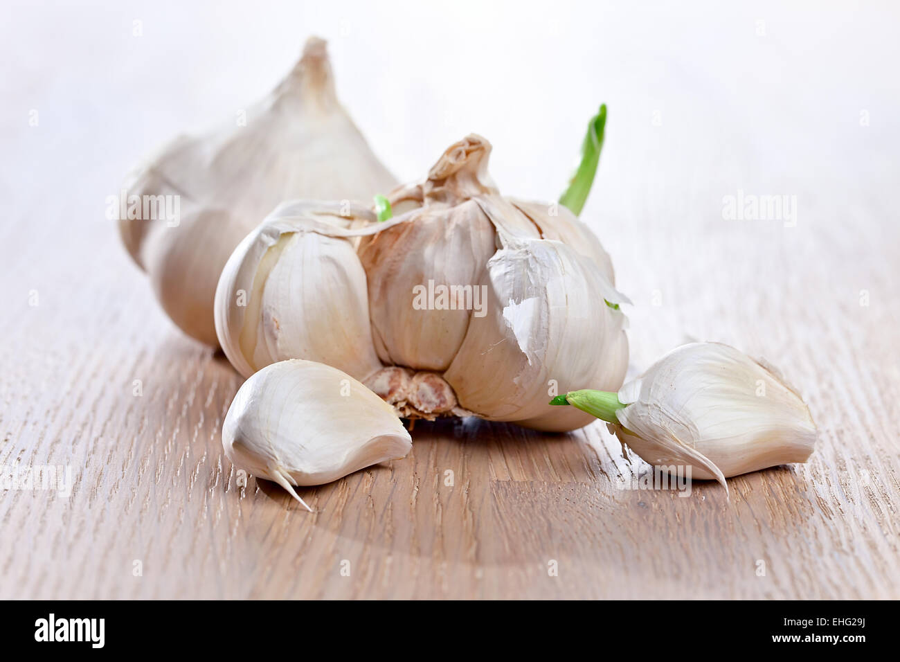 garlic on a old wooden table Stock Photo - Alamy