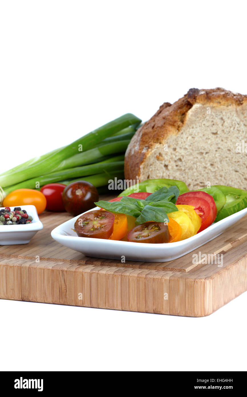 Various organic tomato slices in a bowl Stock Photo