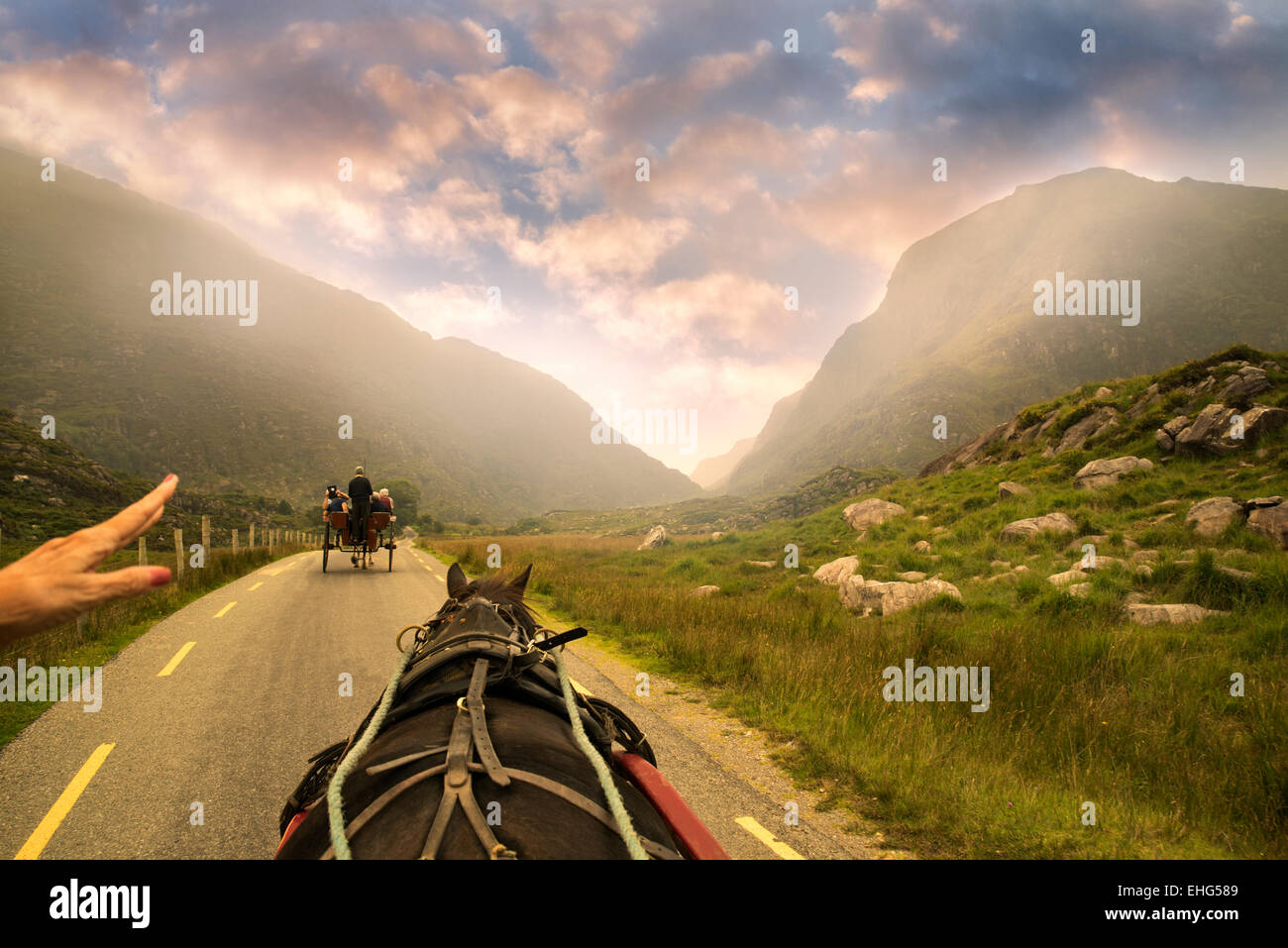 Horse drawn Jaunting Car on road with hand pointing the way. Gap of Dunloe, Ireland Stock Photo