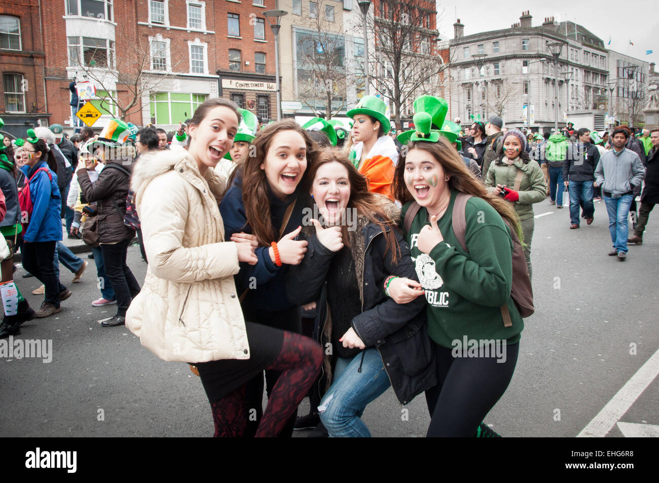 Four happy and excited young women enjoying St Patrick's Day celebrations in O'Connell street in Dublin, Ireland Stock Photo