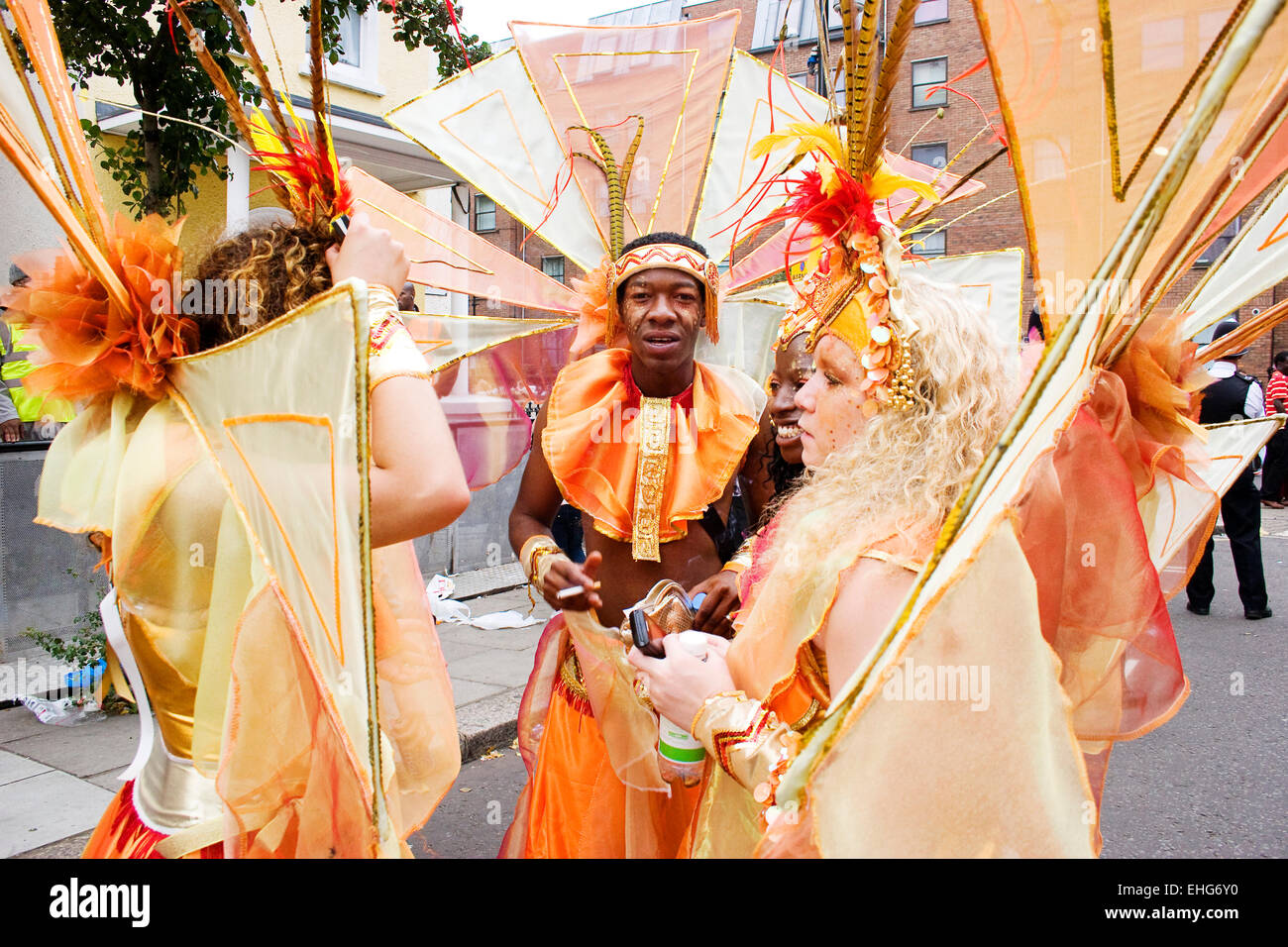 Dancers in costume having a break at the Notting Hill Carnival London. Stock Photo
