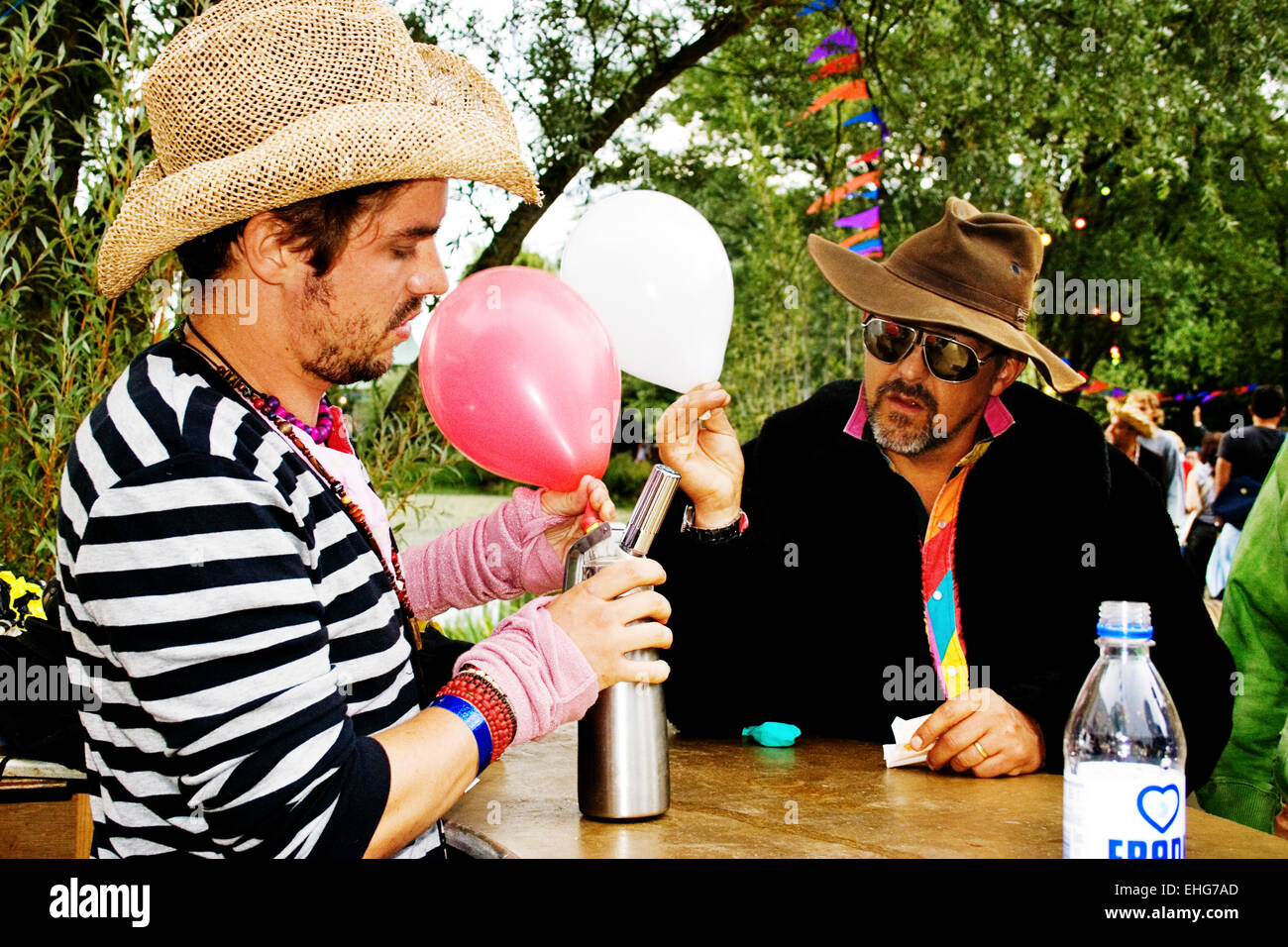 Guy buying Laughing Gas filled balloons at a festival Stock Photo Alamy