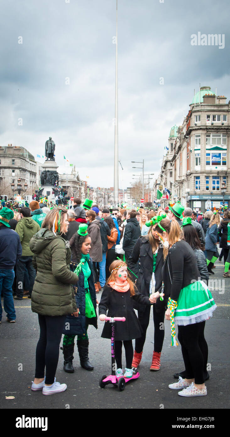 Young girl with Facepaint with 4 young women wearing green attending the St Patrick's day festival in Dublin's O'Connell street Stock Photo