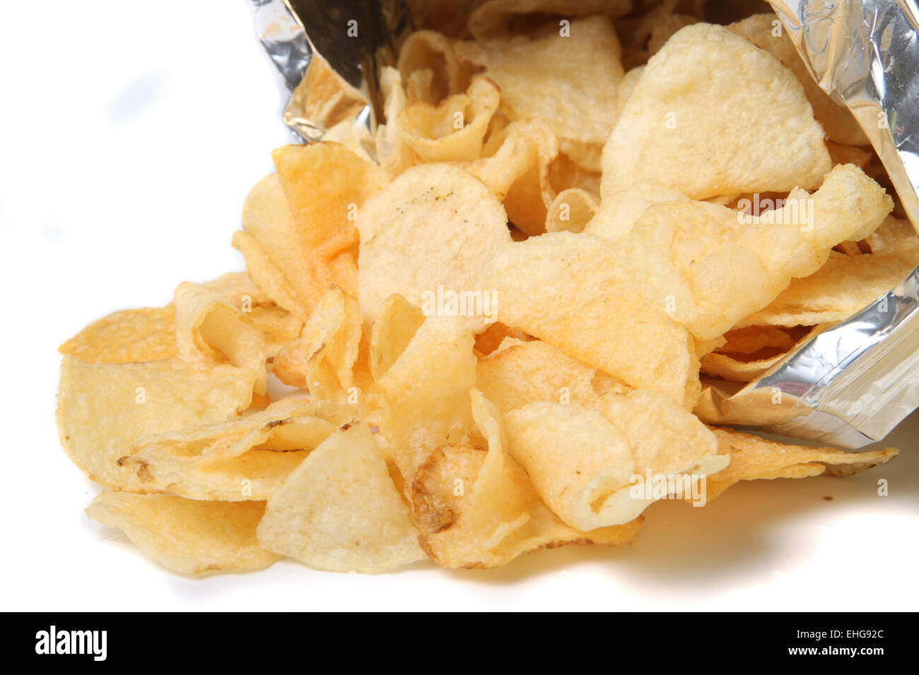 Bag of kettle chips spilling over on a white background Stock Photo Alamy