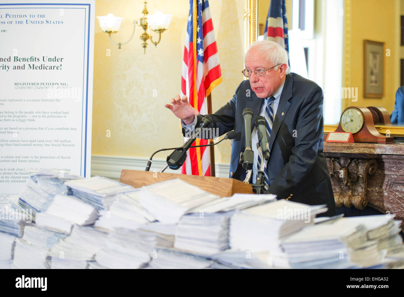 Bernie Sanders Signing Stuff Democratic Senator Bernie Sanders stands behind piles of petitions ...