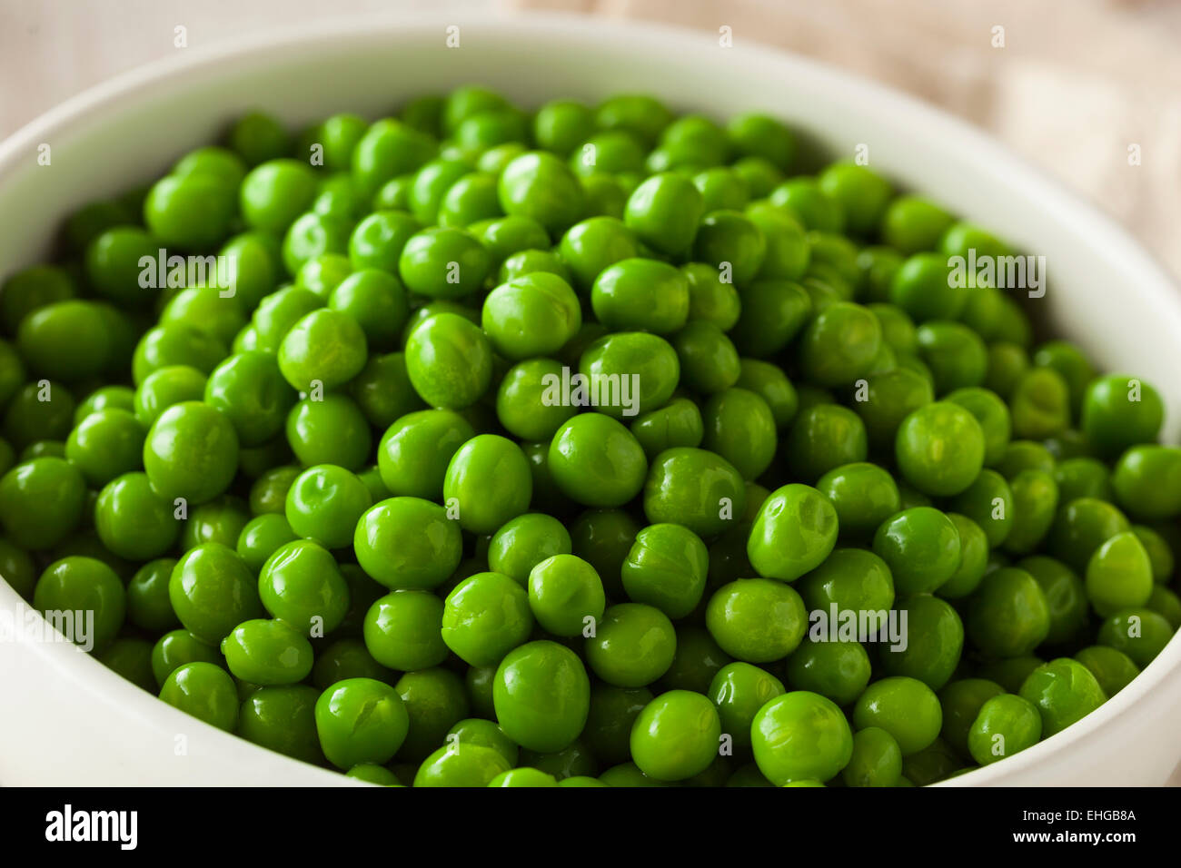 Organic Steamed Fresh Green Peas in a Bowl Stock Photo