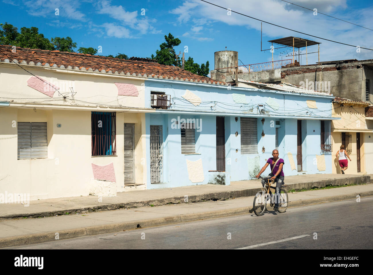 Cuba Santa Clara street road scene primitive houses homes blue cream