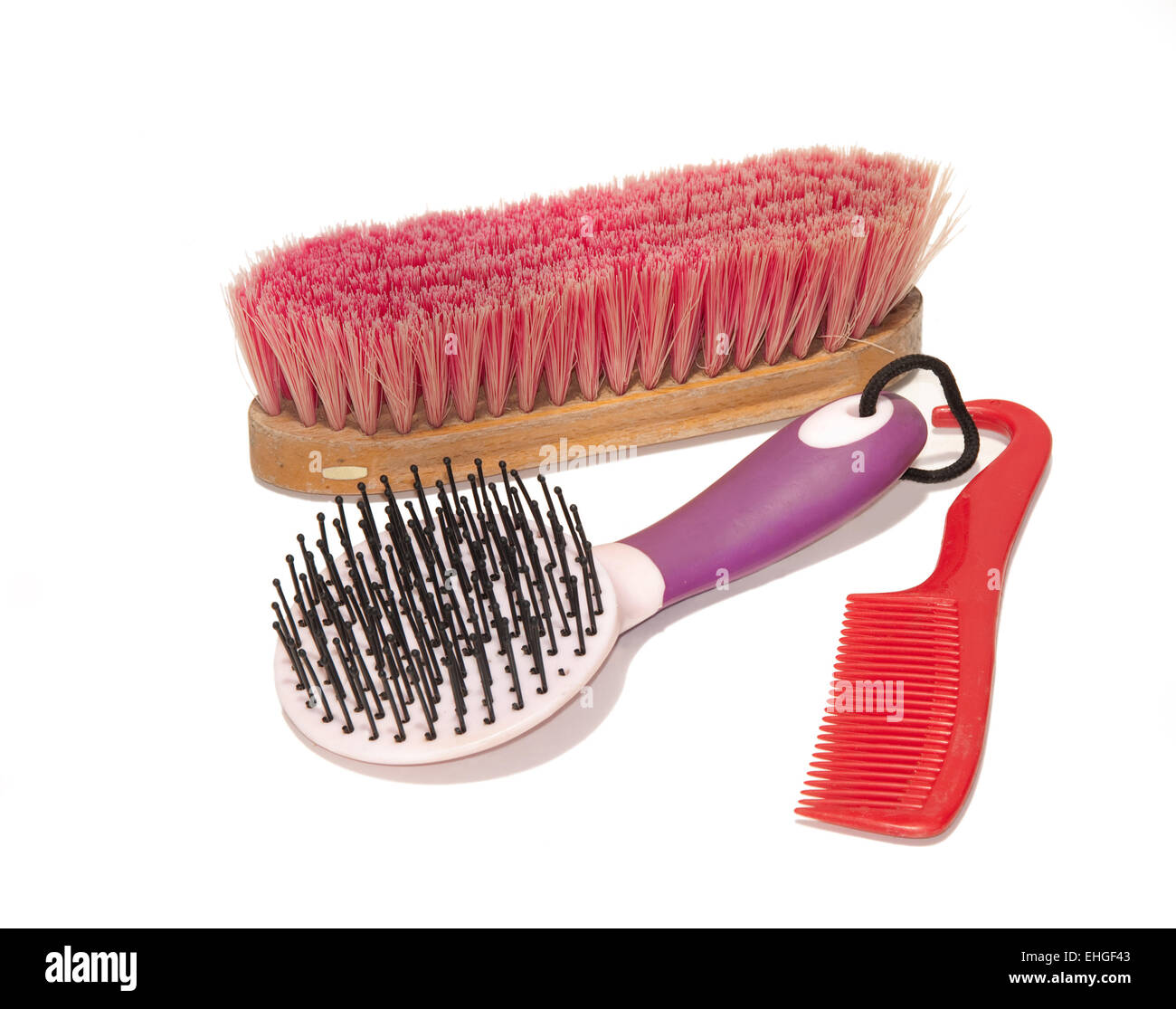 Horse grooming supplies - a soft brush, a mane and tail brush and a comb-hoof pick combo Stock Photo