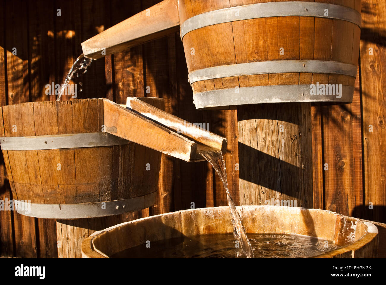 Wooden barrels funnel water through chutes Stock Photo Alamy