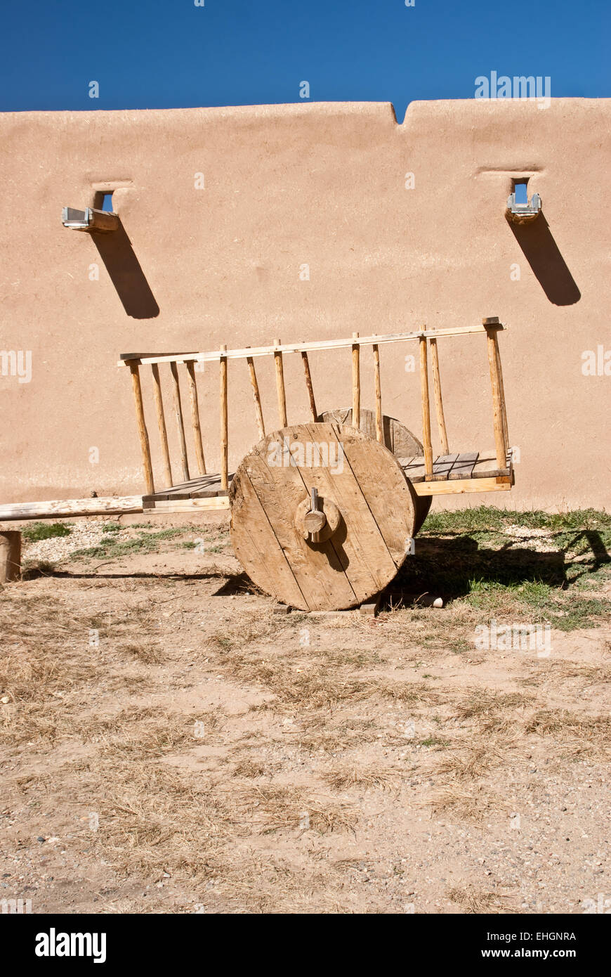 Old Mexican wooden cart at adobe walls Stock Photo