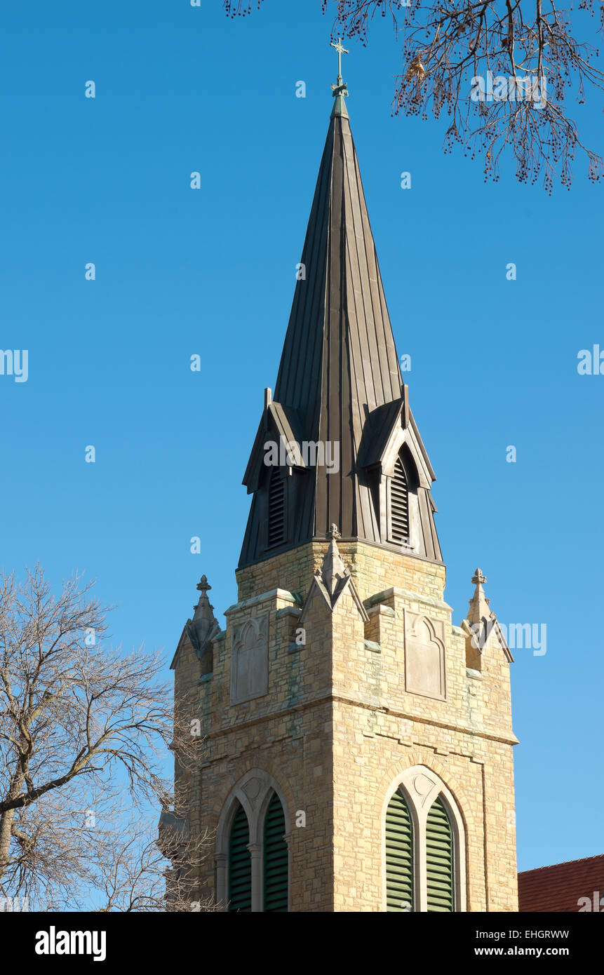 steeple and belltower atop church of neogothic architecture Stock Photo