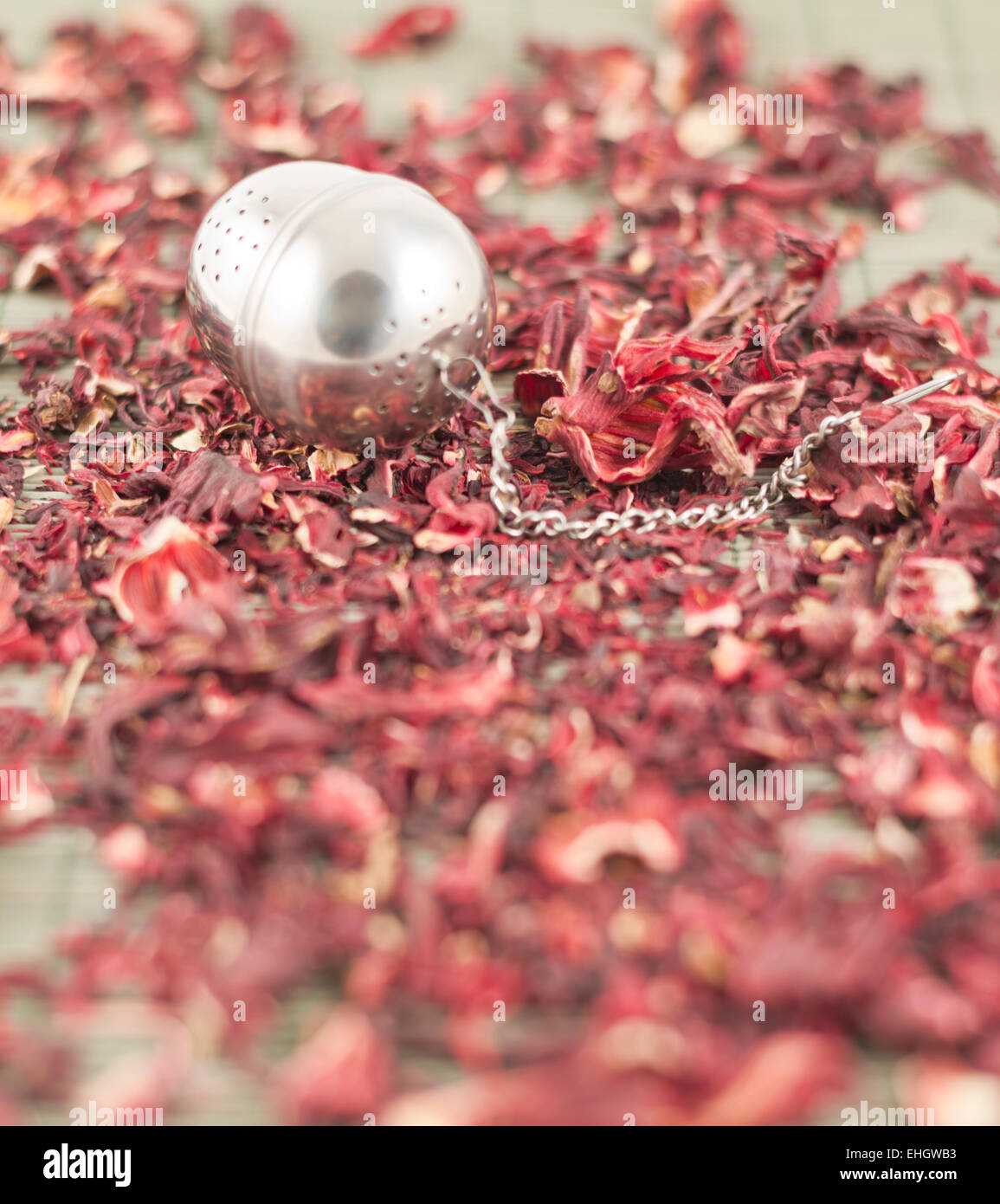 Tea infuser over red tea Stock Photo Alamy