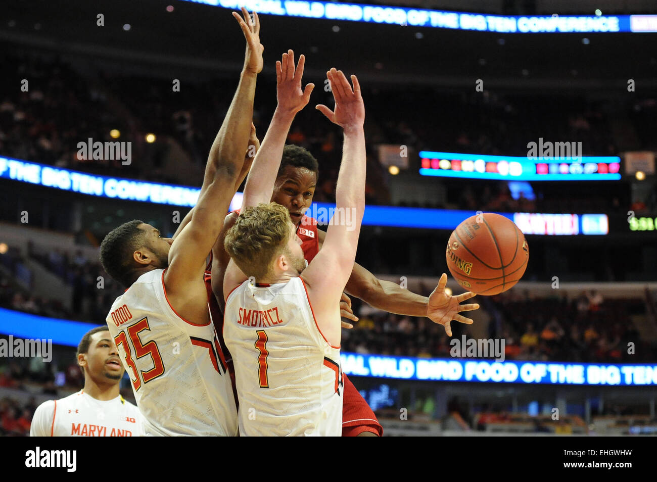 Chicago, IL, USA. 13th Mar, 2015. Indiana Hoosiers guard Yogi Ferrell (11) passes away from Maryland Terrapins forward Damonte Dodd (35) and Maryland Terrapins forward Evan Smotrycz (1) in the first half during the 2015 Big Ten Men's Basketball Tournament game between the Indiana Hoosiers and the Maryland Terrapins at the United Center in Chicago, IL. Patrick Gorski/CSM/Alamy Live News Stock Photo