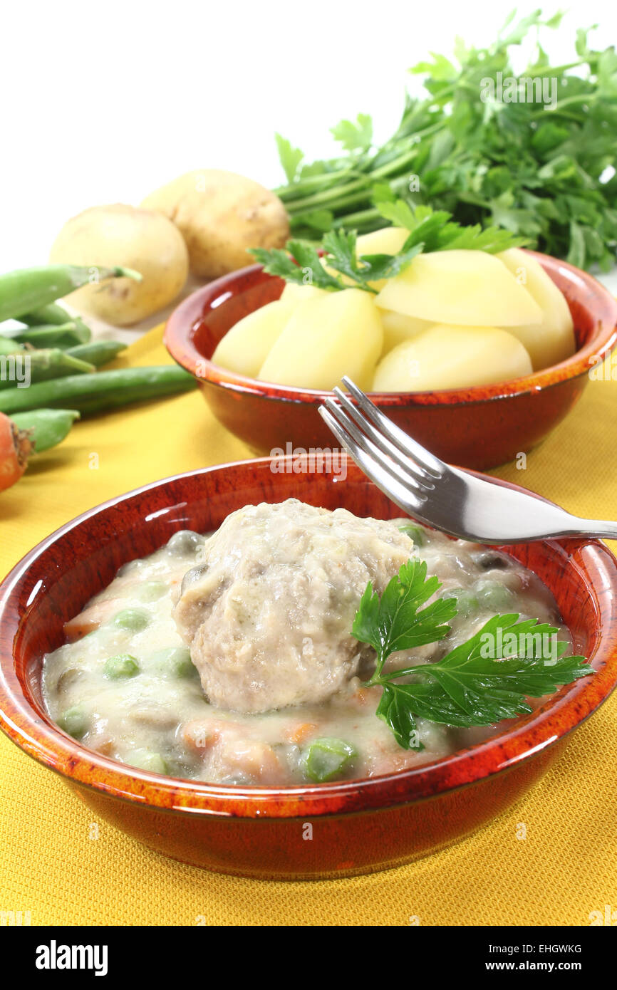 cooked meatballs in a white sauce with capers Stock Photo Alamy