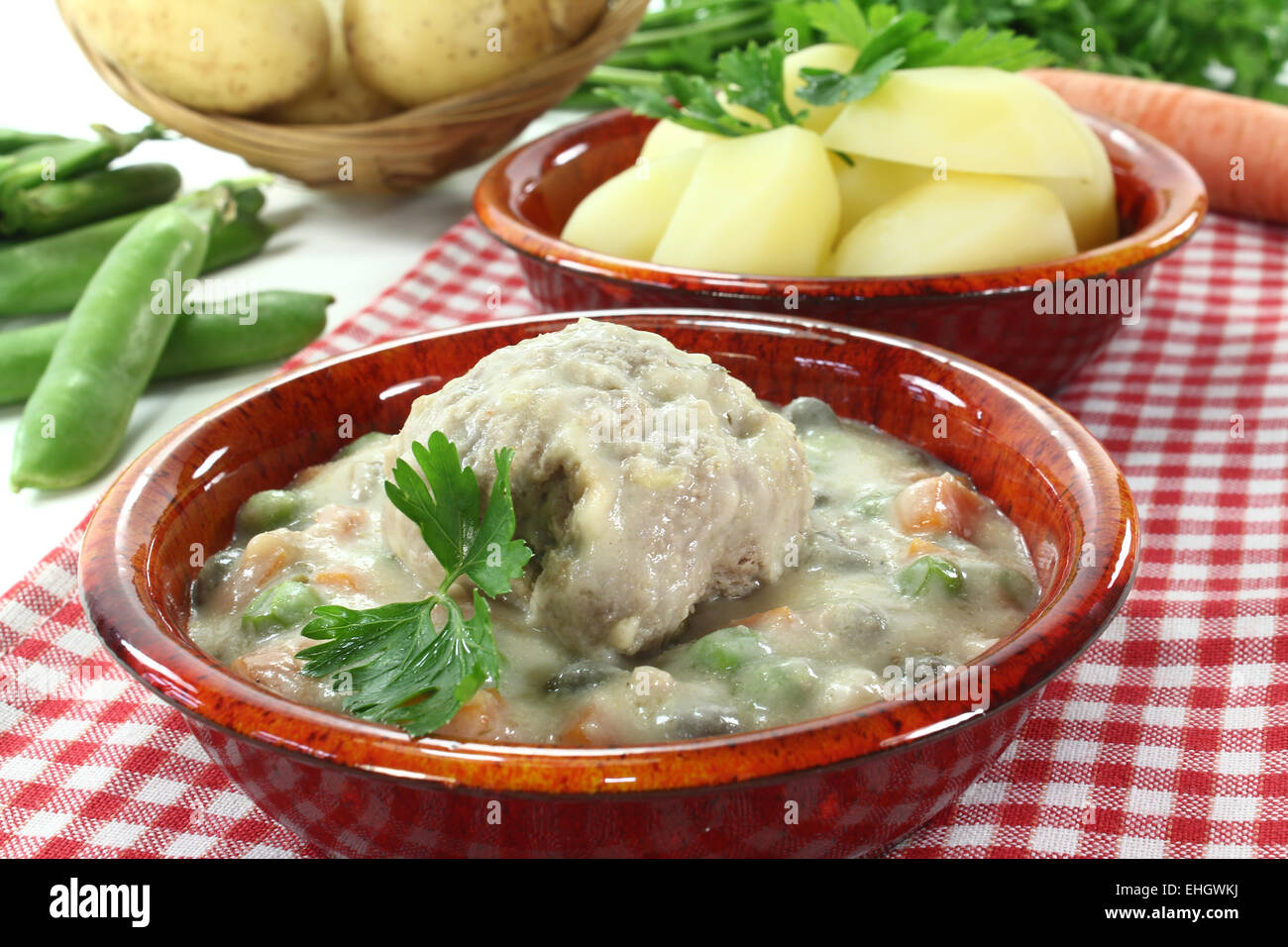 cooked meatballs in a white sauce with parsley Stock Photo