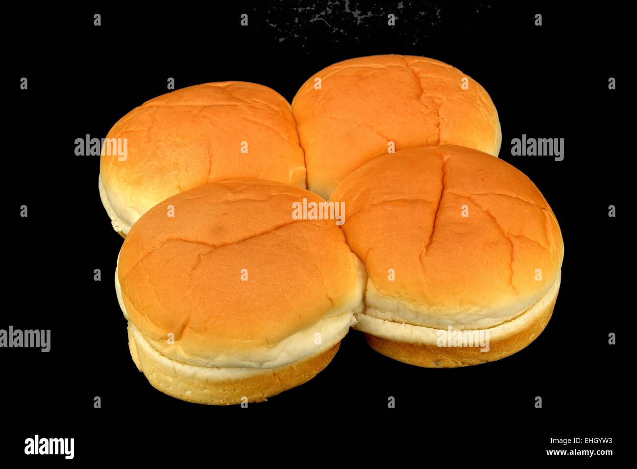 Four hamburger buns on a black background Stock Photo Alamy