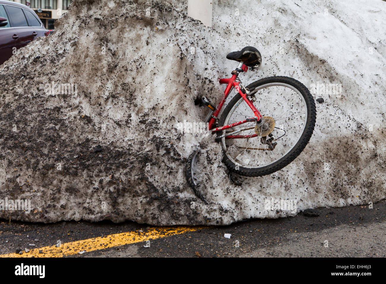 Bicycle stuck in plowed snow pile - USA Stock Photo