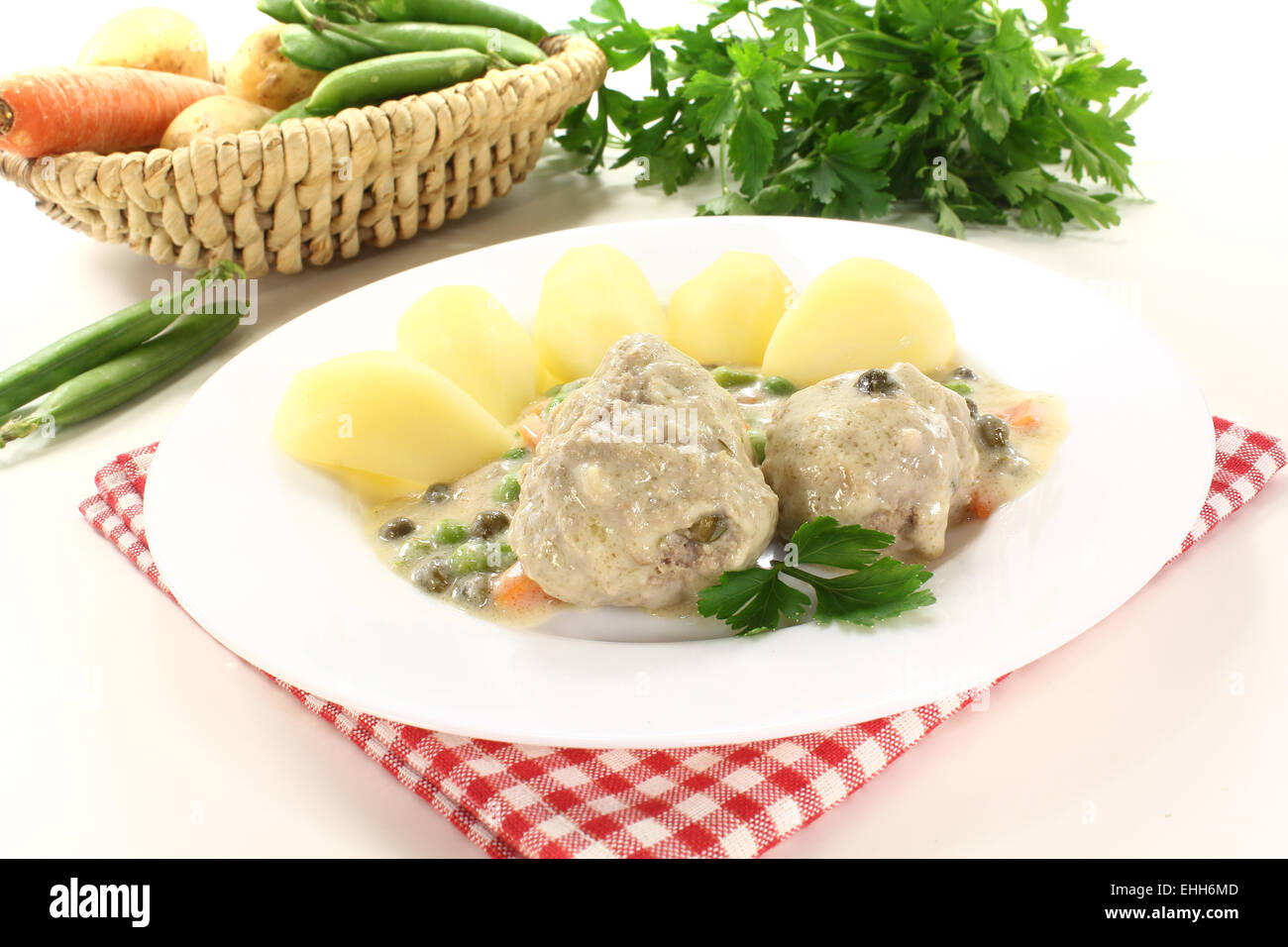 meatballs in a white sauce with capers Stock Photo