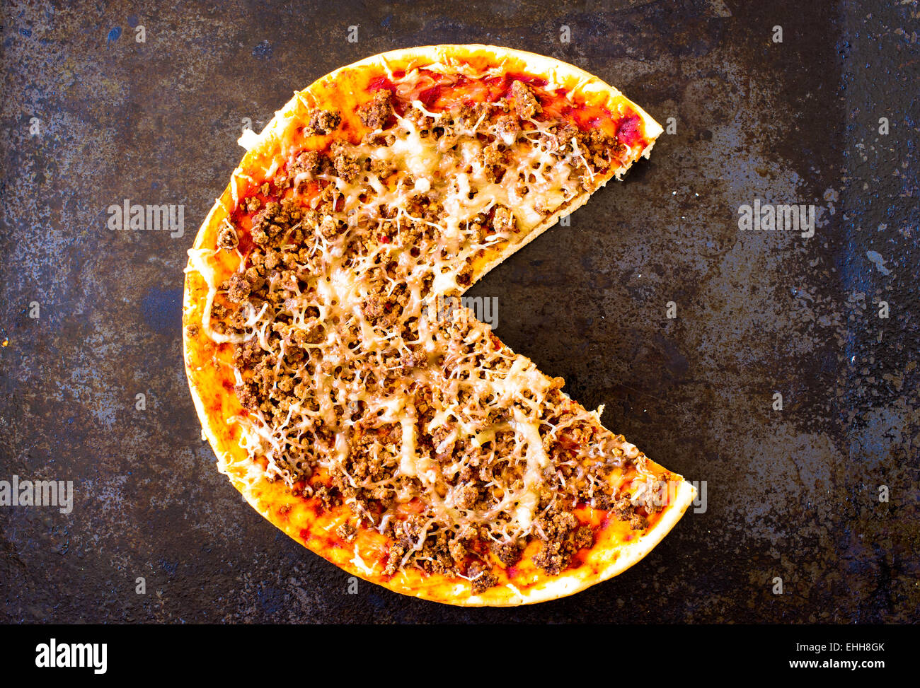 Pizza with minced meat and cheese on the stove top view Stock Photo