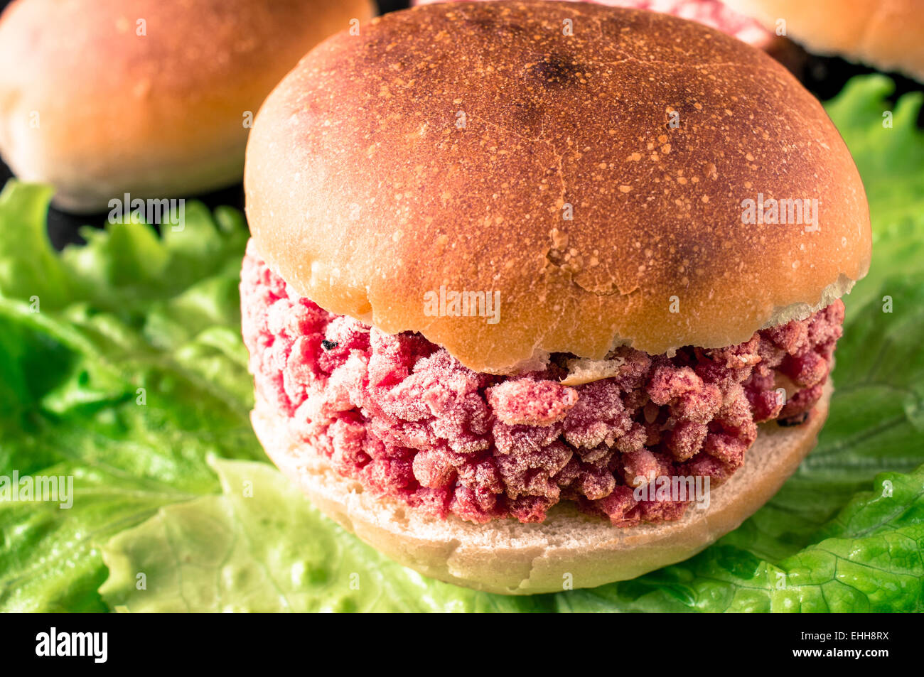 Frozen hamburger ground beef on lettuce Stock Photo Alamy