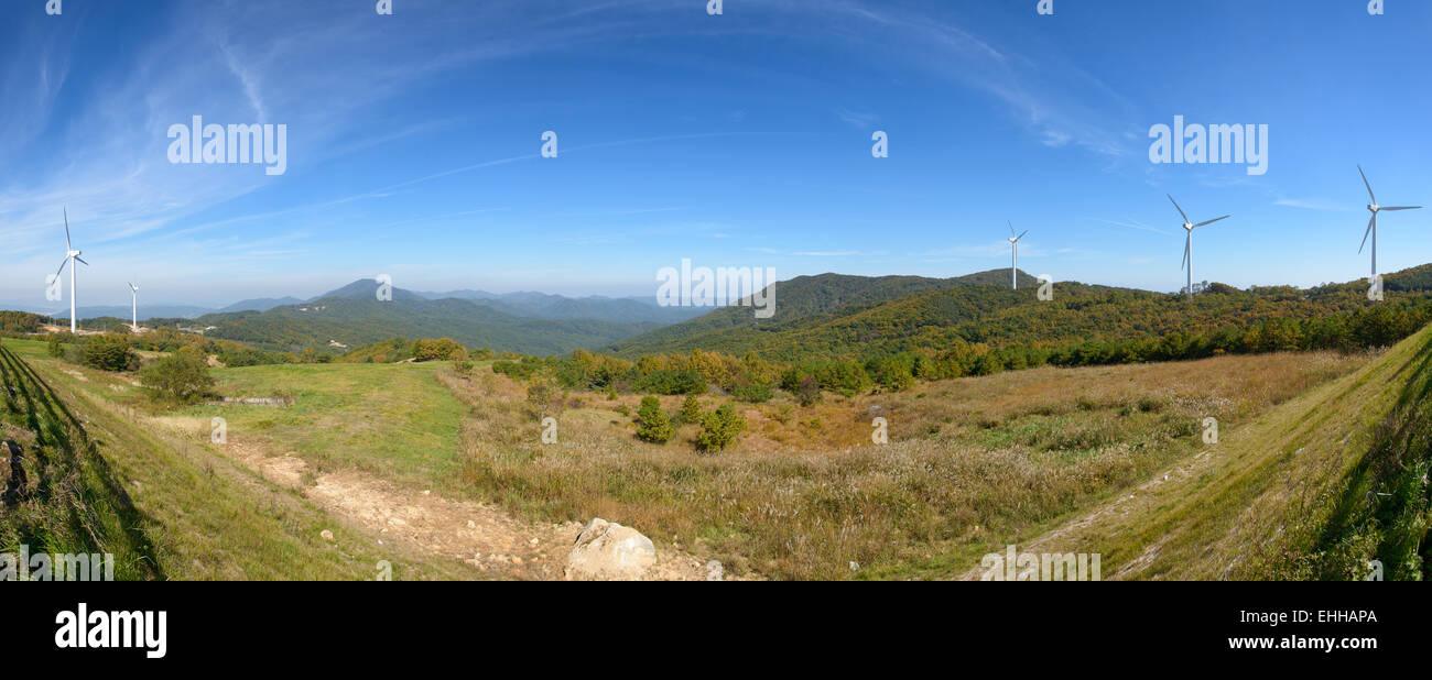 wind generator in a mountain with cloudy sky Stock Photo