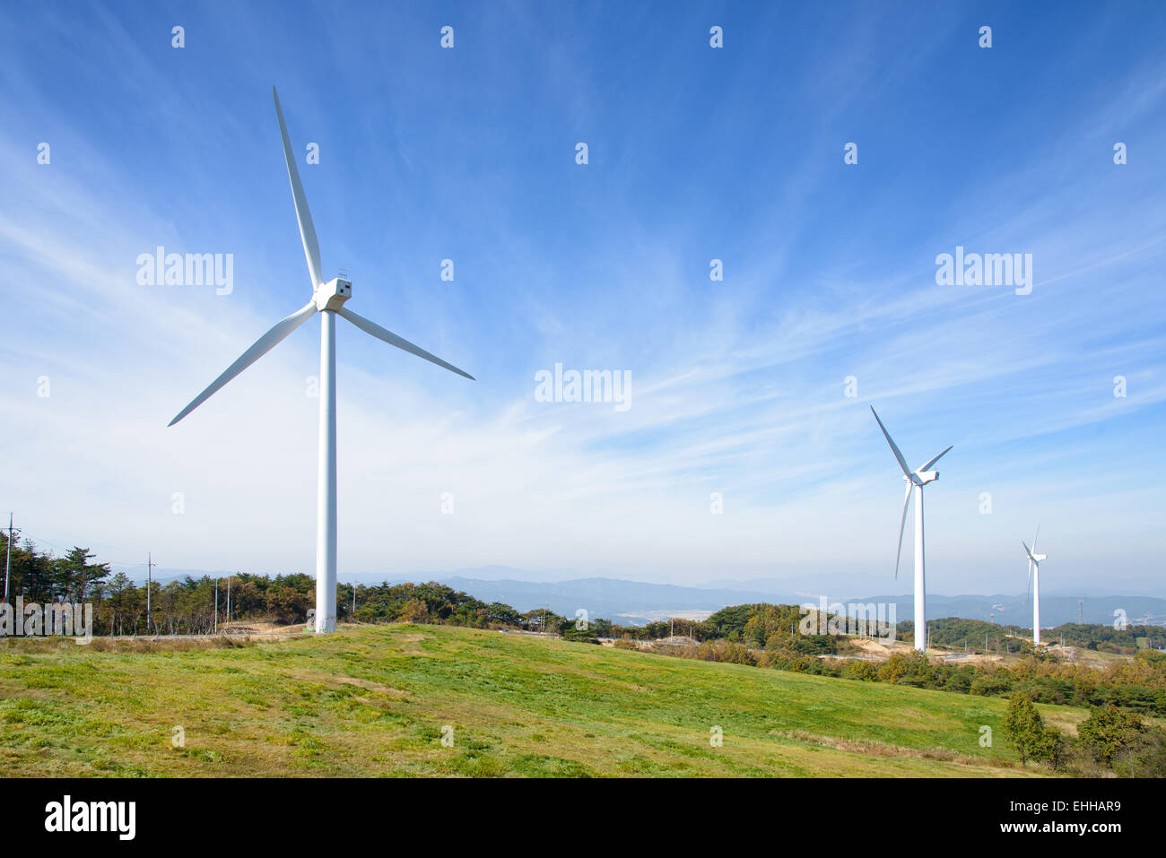 wind generator in a mountain with cloudy sky Stock Photo