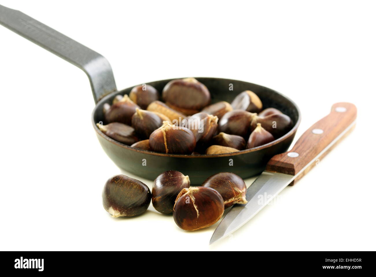 Knife and the chestnuts in a pan. Stock Photo