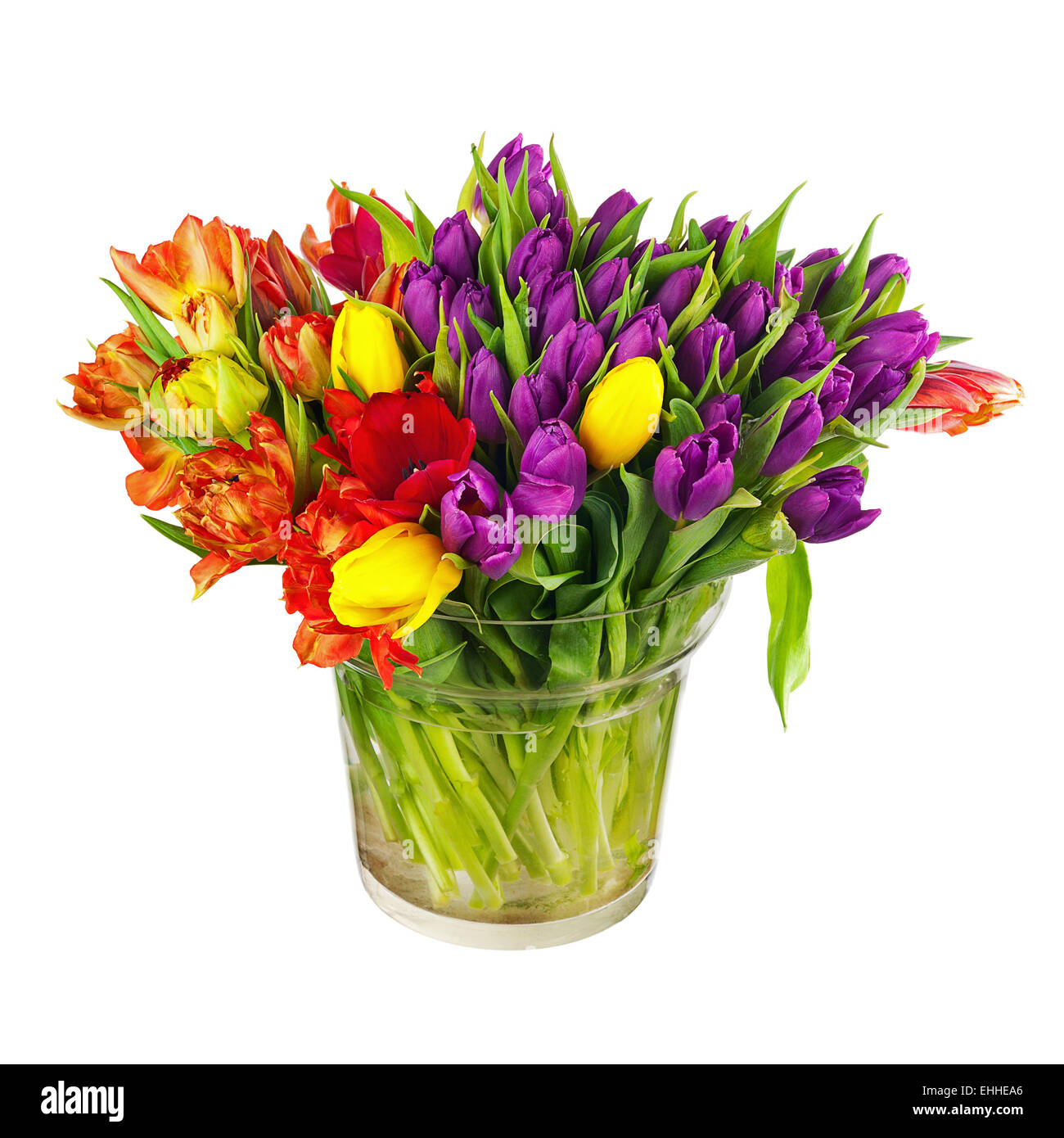 Flower bouquet from colorful tulips in glass vase isolated on white ...