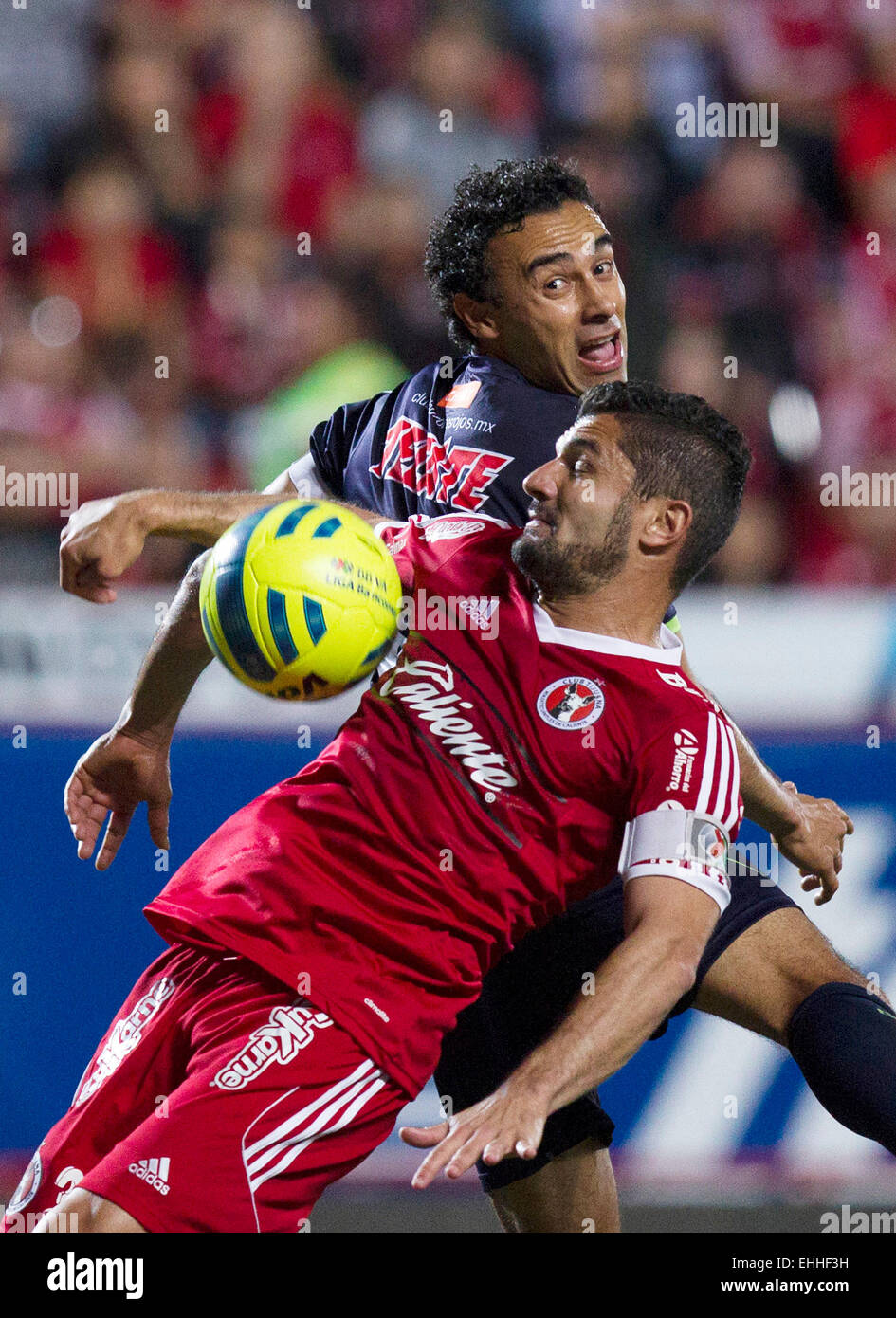Tijuana, Mexico. 13th Mar, 2015. Javier Gandolfi (FRONT) of Xolos vies for the ball with Leobardo Lopez of Veracruz during a match of Journey 10 of MX League Clousure Tournament 2015 at Caliente Stadium in Tijuana City, northeast Mexico, on March 13, 2015. Credit:  Guillermo Arias/Xinhua/Alamy Live News Stock Photo
