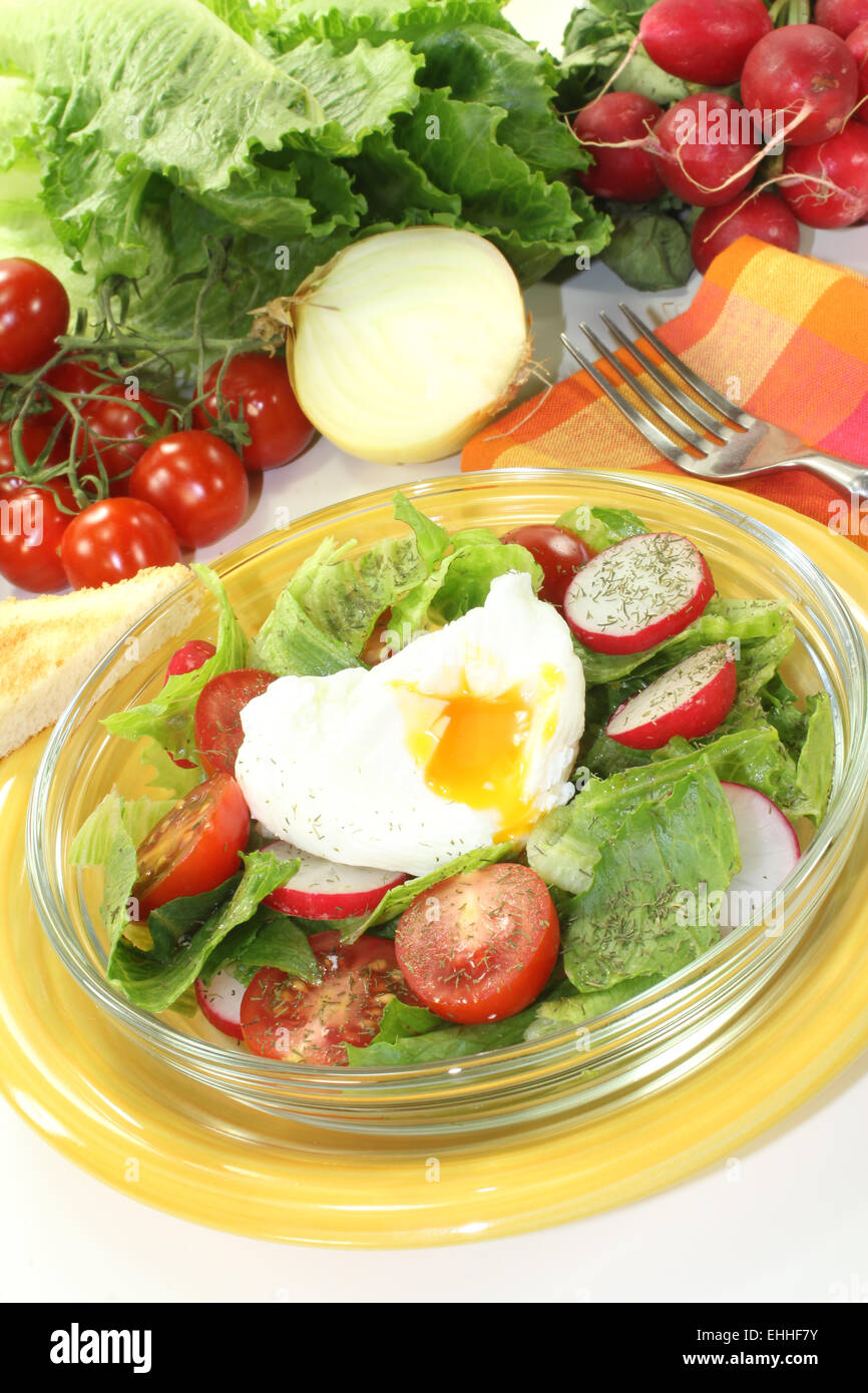 salad with poached egg and tomatoes Stock Photo
