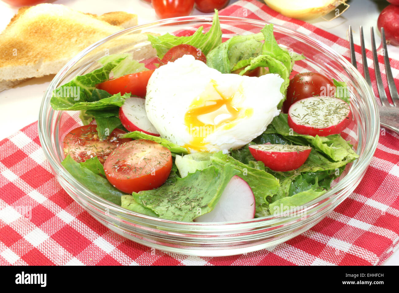 salad with poached egg, tomatoes and radishes Stock Photo