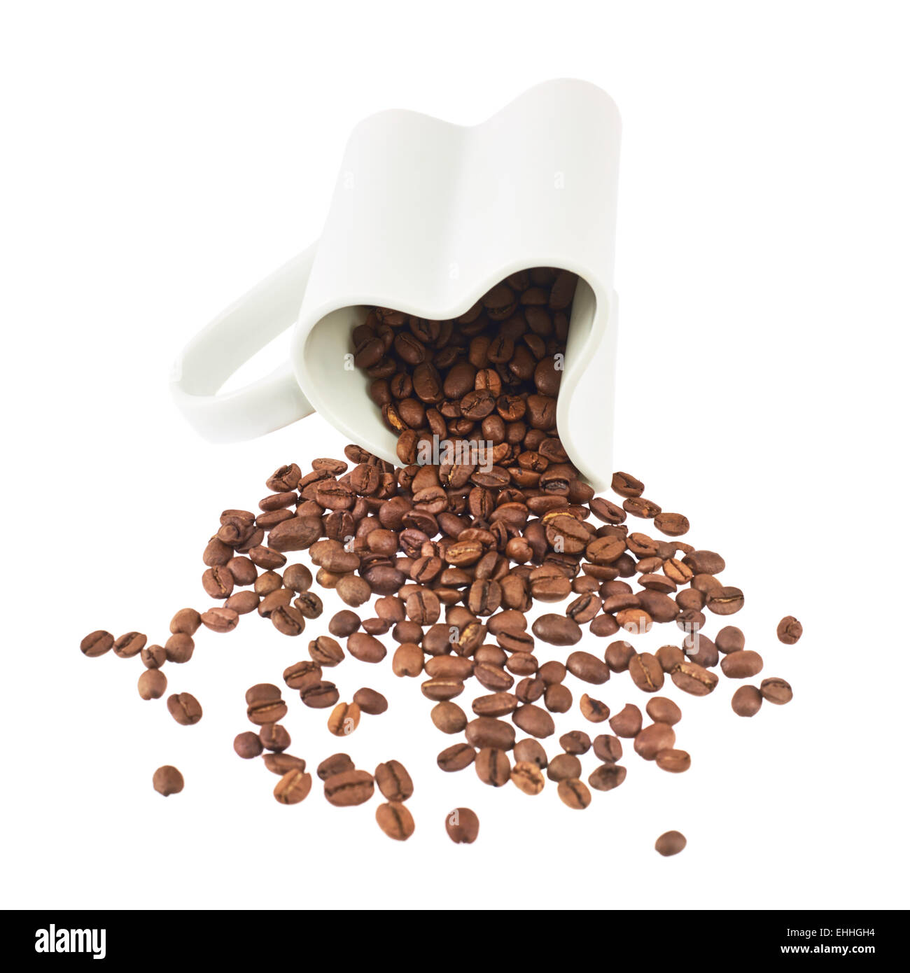 Coffee beans falling out of cup Stock Photo - Alamy