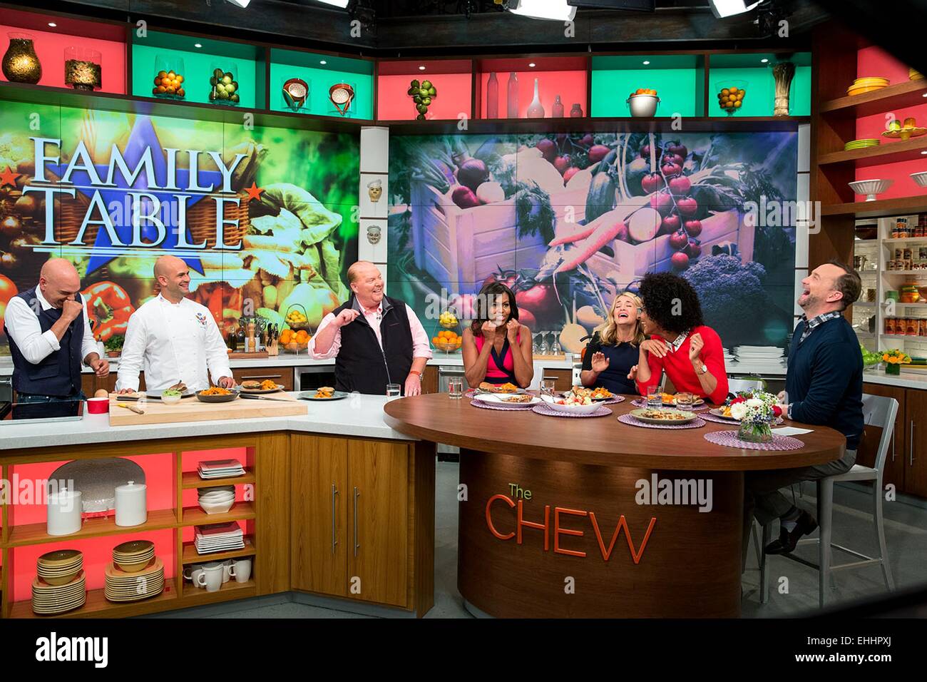 US First Lady Michelle Obama tapes a segment of television show The Chew September 23, 2014 in New York, N.Y. Participants with the First Lady from left are: Michael Symon, Sam Kass, Mario Batali, Daphne Oz, Carla Hall and Clinton Kelly. Stock Photo