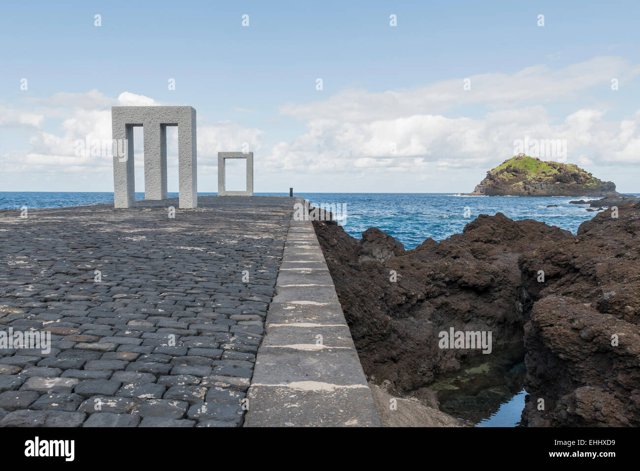 Pier of Garachico on Tenerife in Spain with art, island and lava rocks. Stock Photo