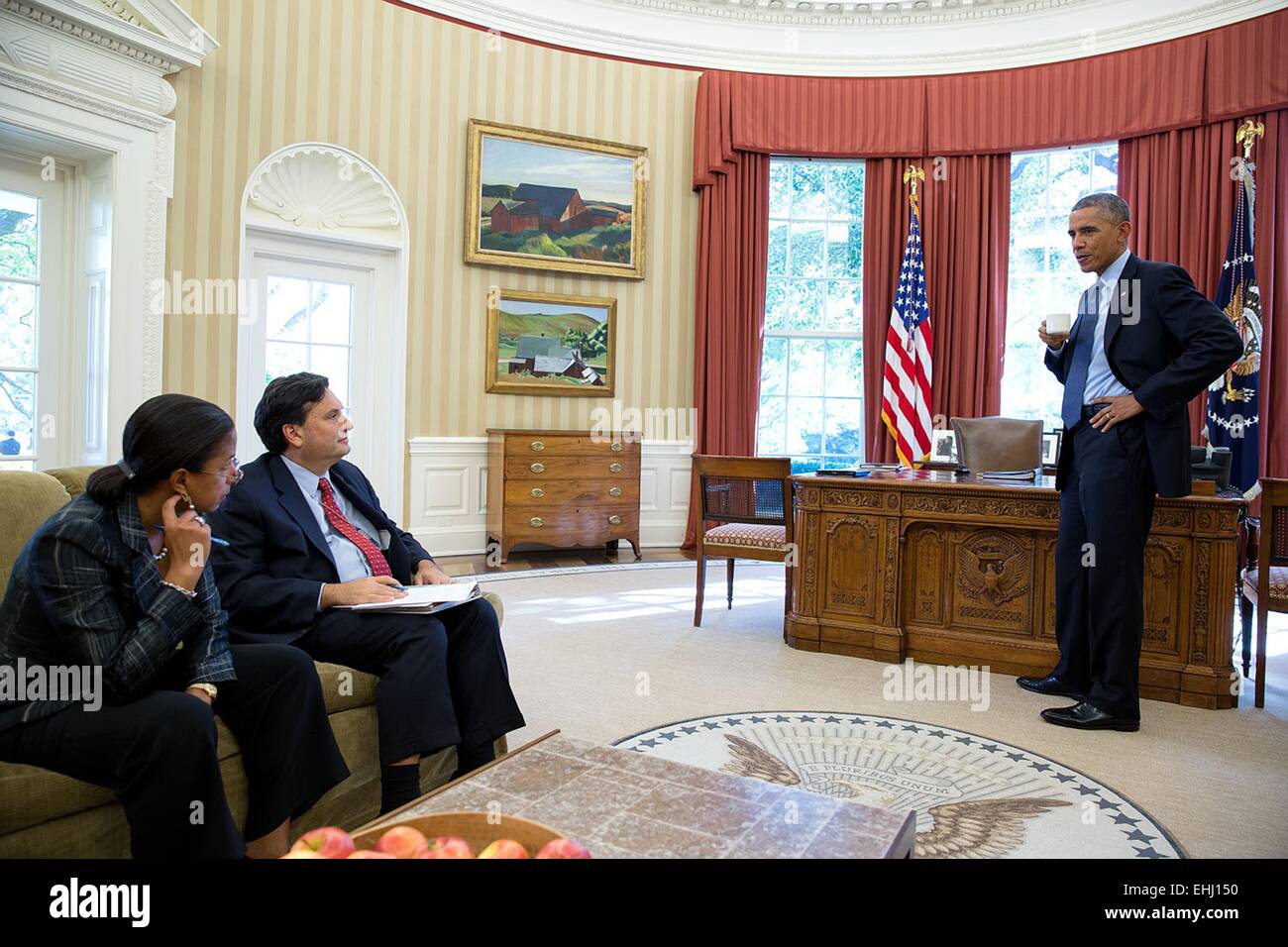 US President Barack Obama talks with National Security Advisor Susan E. Rice and Ebola Response Coordinator Ron Klain following a conference call with health care workers in Africa regarding Ebola in the Oval Office of the White House October 28, 2014 in Washington, DC. Stock Photo