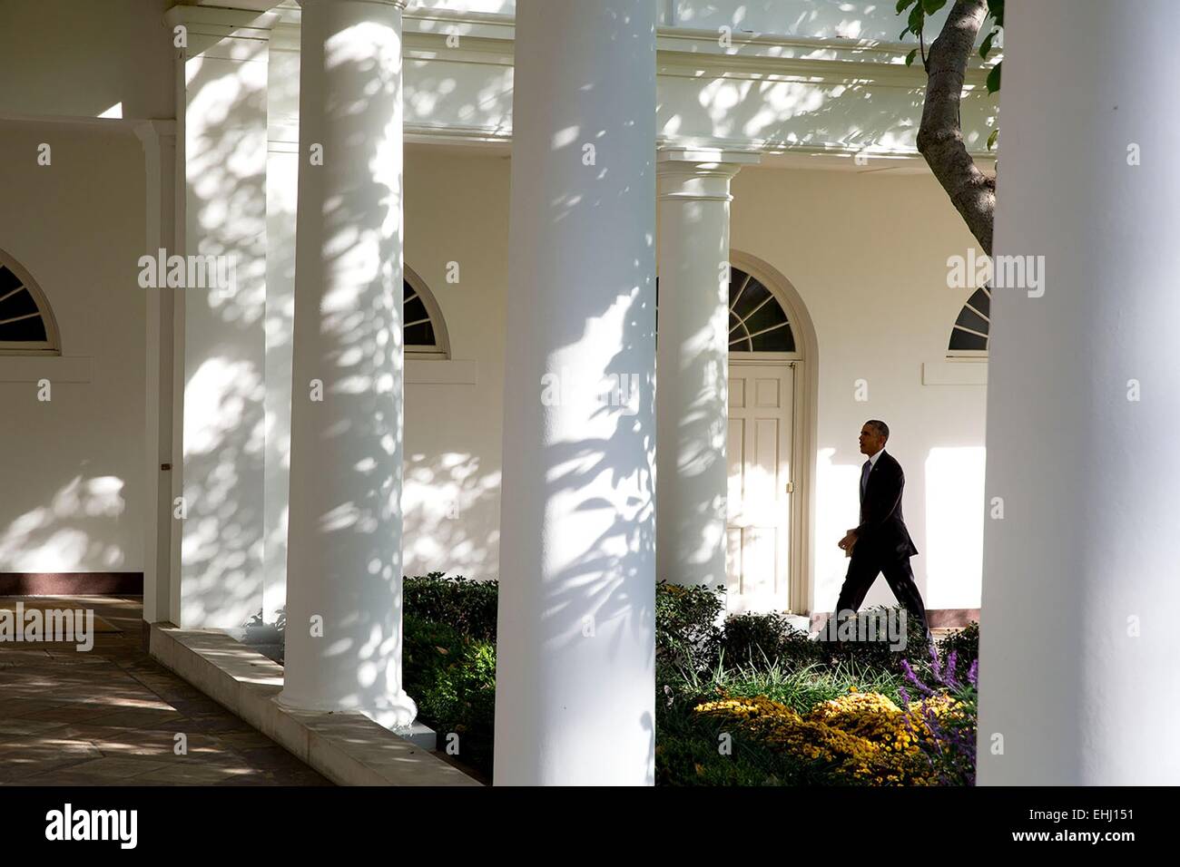 US President Barack Obama walks on the Colonnade of the White House October 29, 2014 in Washington, DC. Stock Photo