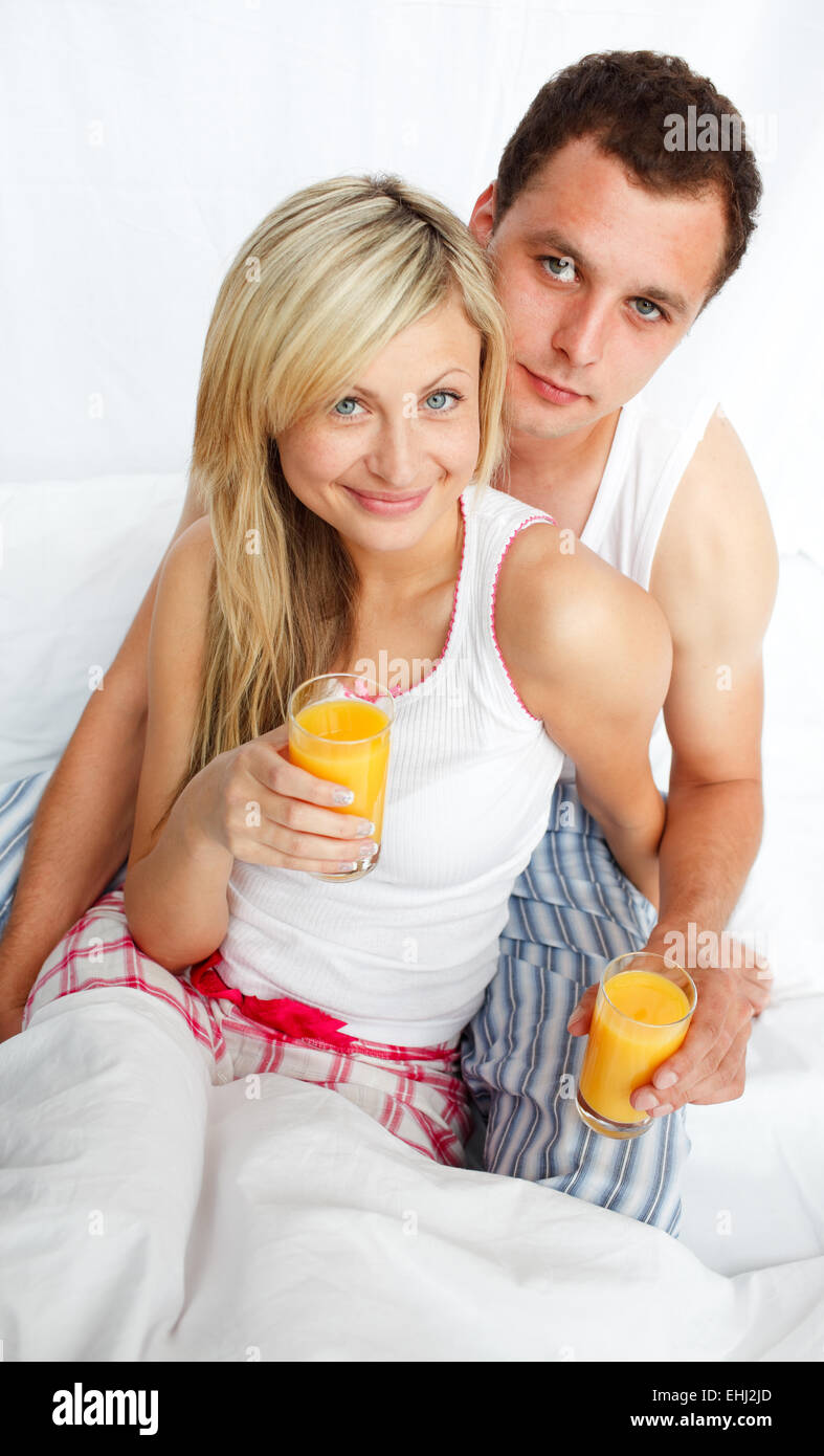 Couple drinking orange juice in bed Stock Photo Alamy