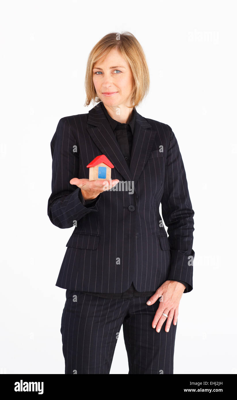Businesswoman presenting model of house Stock Photo - Alamy