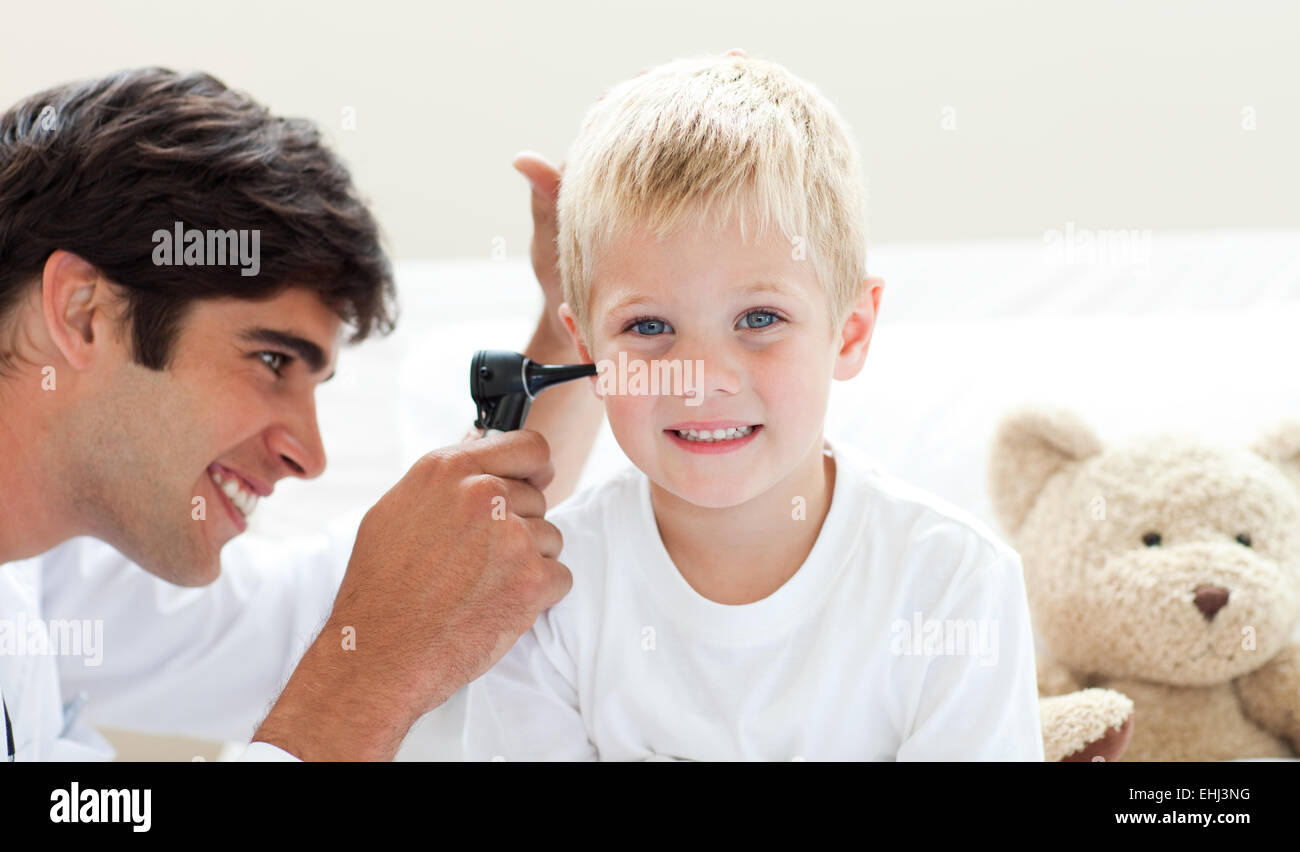 Attractive doctor checking his patient's ears Stock Photo