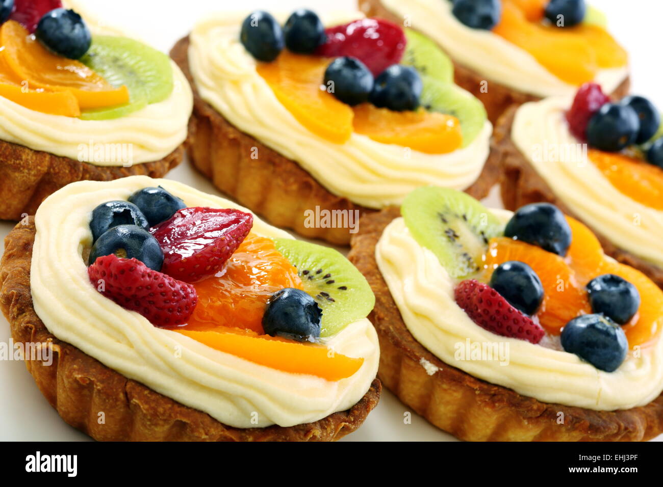 Cream cakes and fruit. Stock Photo